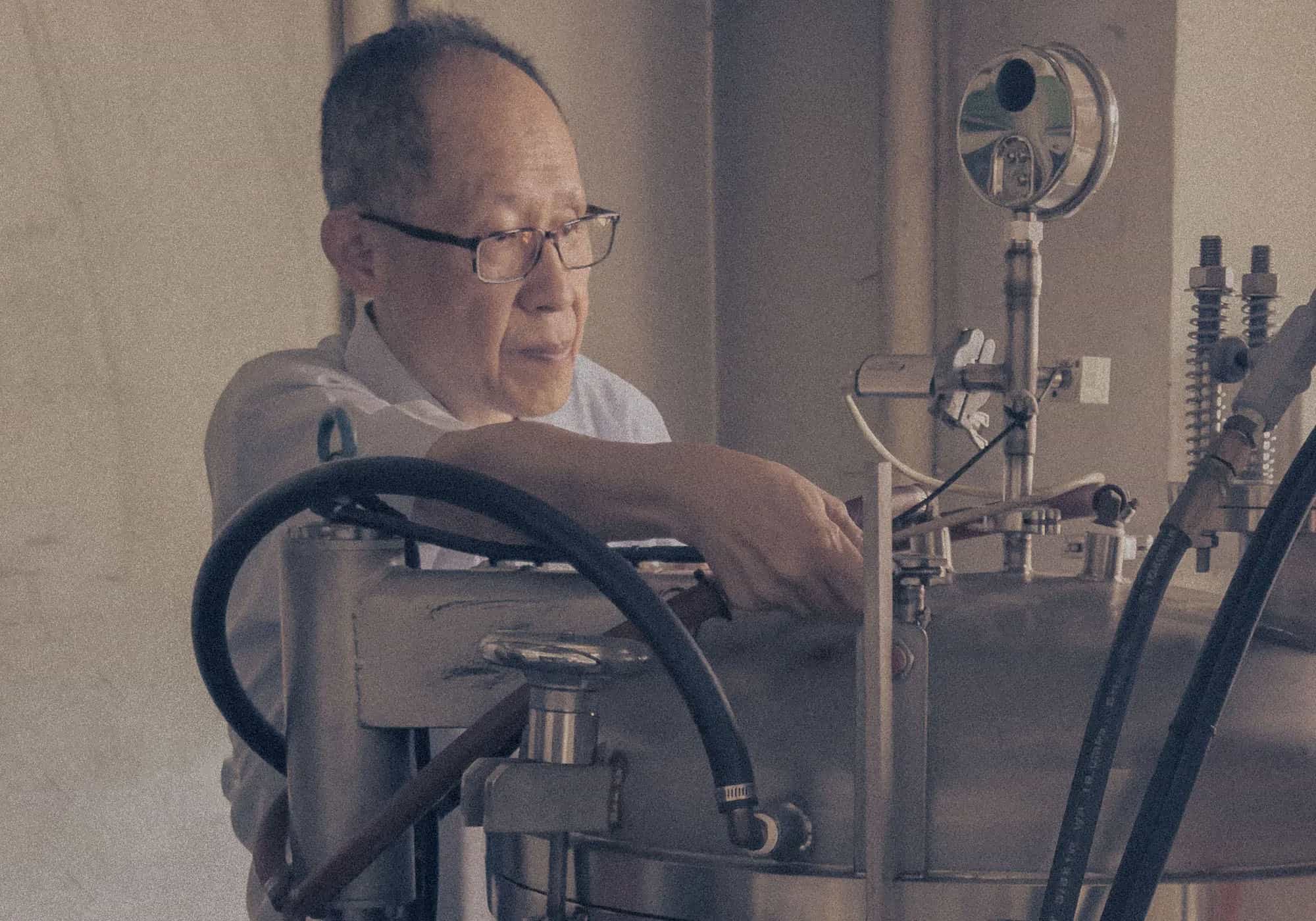 Scientist adjusting lab equipment with gauges and tubes