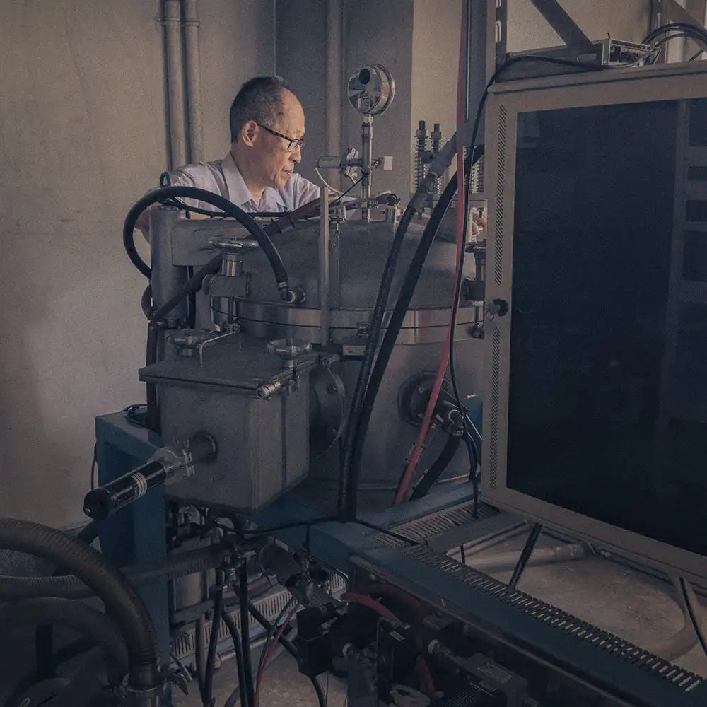 Scientist working with complex machinery in a laboratory