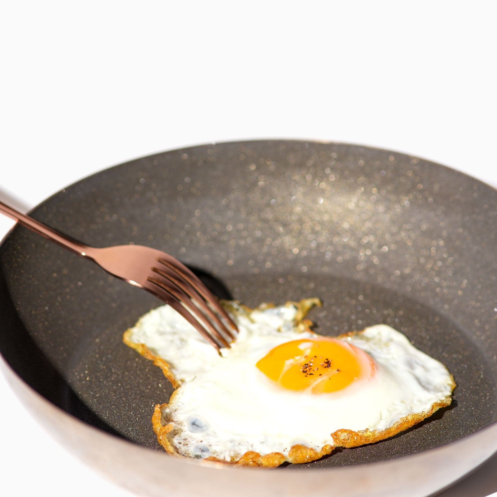 Fried egg on a pan with a fork