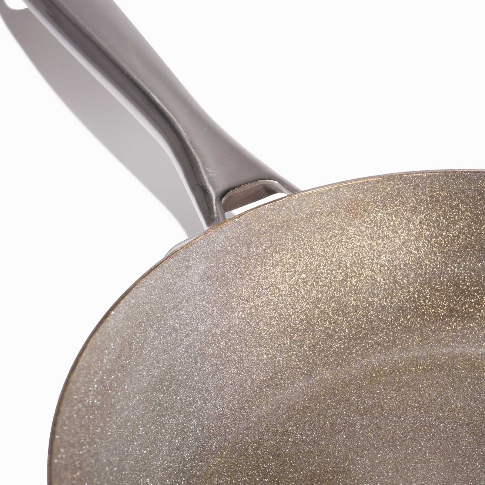 Close-up of a diamond frying pan with a speckled nonstick surface and a modern handle
