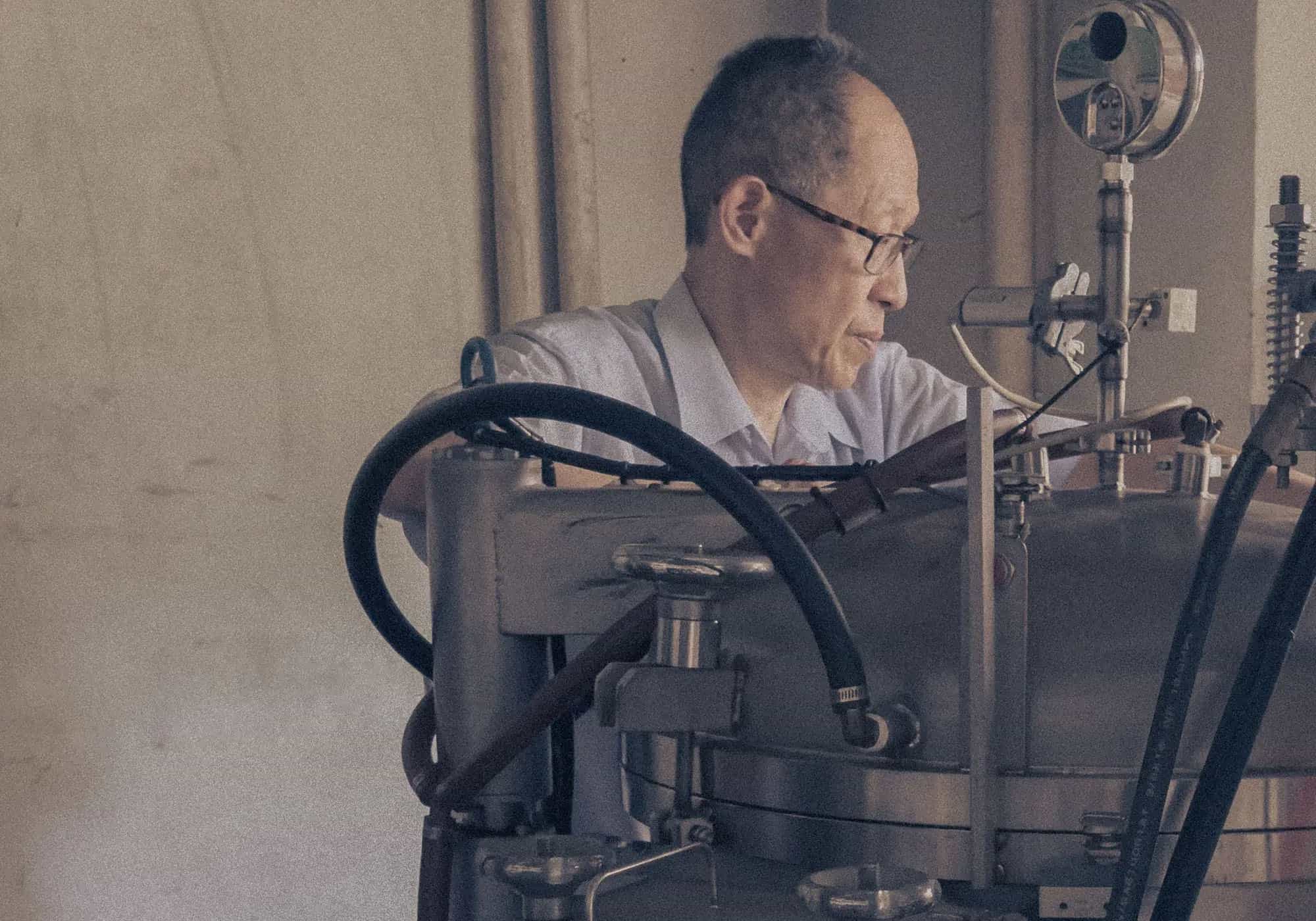 Focused scientist working on industrial lab machinery