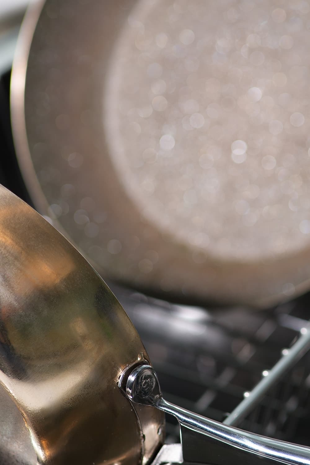 diamond cookware placed inside dishwasher rack for cleaning